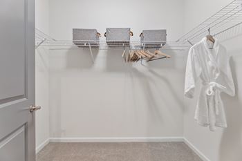 Spacious walk-in closets with custom wood shelving
